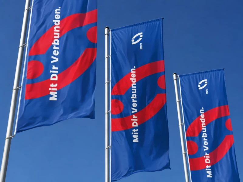 MDV-Fahnen flackern vor einem wolkenlosen Himmel im Wind.